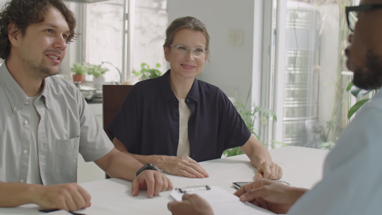 Married Couple and Sales Representative Striking Deal in Office