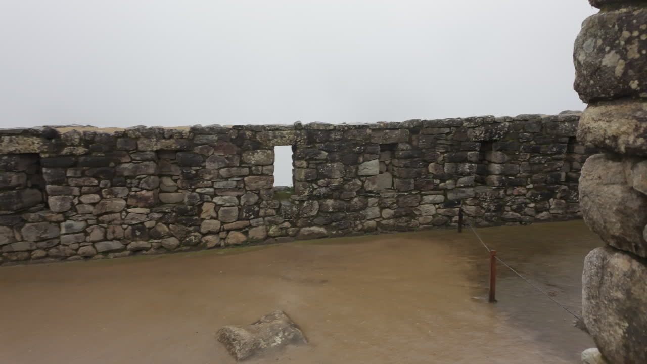Slow motion video of Inca stone structures inside Machu Picchu, showing ancient walls and architecture in Peru