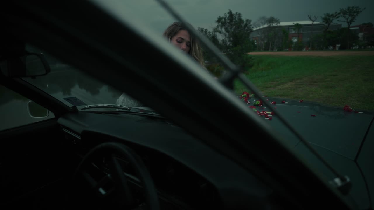 Woman with Flowers by a Vintage Car