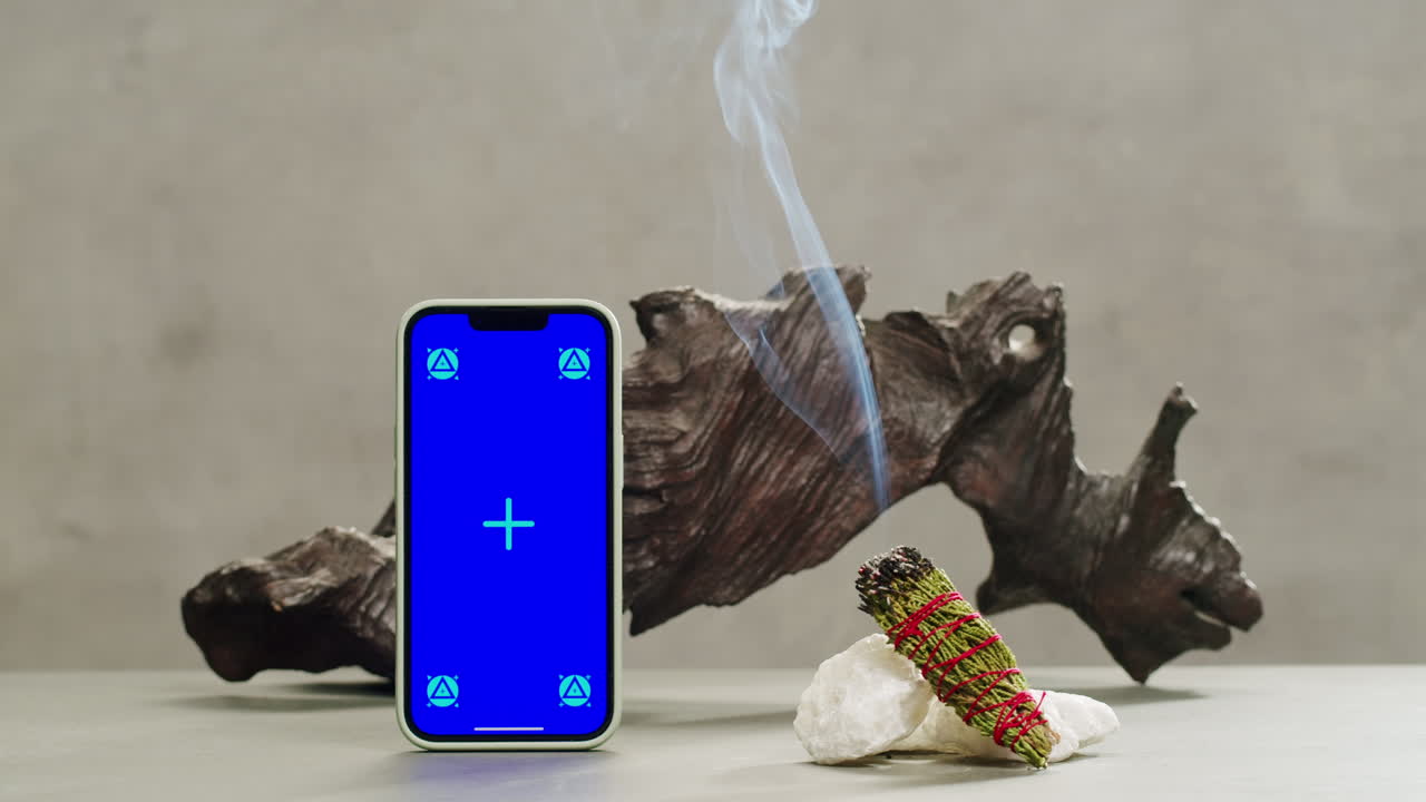 Person holding Palo Santo wood stick in hand, aromatic Palo Santo burning on black background, smoke spreading around, slow motion video clip, high quality 4k close up footage. High quality 4k footage