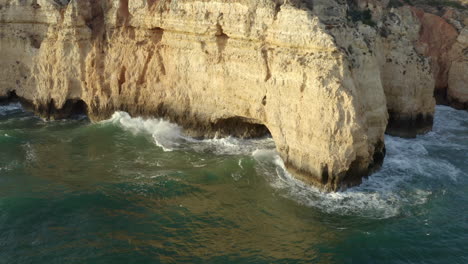 close up of a hole in a shore cliff from algarve