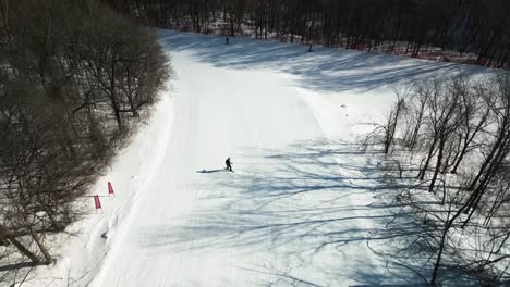 aerial gootage of a young snowboarder doing downhill ride at yabuli resort