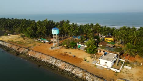 aerial drone shot of an island village surrounded by coconut trees in udupi