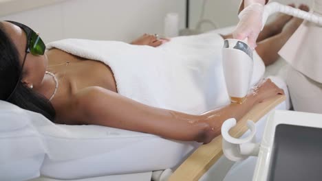 laser epilation and cosmetology in beauty salon. cosmetology, spa and hair removal concept. laser hair removal procedure of female. doctor in gloves.
