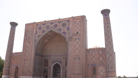 outside fascade of islamic madrassa in samarkand, uzbekistan along the historic silk road