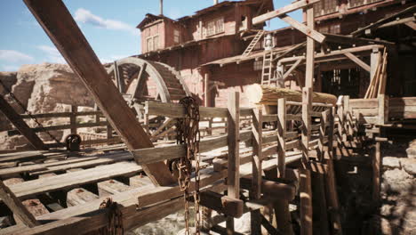 detailed view of wooden waterwheel structure at an old mining site in daylight