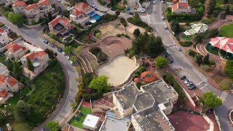 aerial view of a residential neighborhood with houses, roads, and a public park