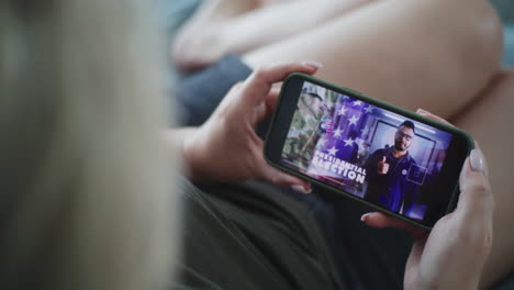 woman viewing presidential election campaign video on smartphone