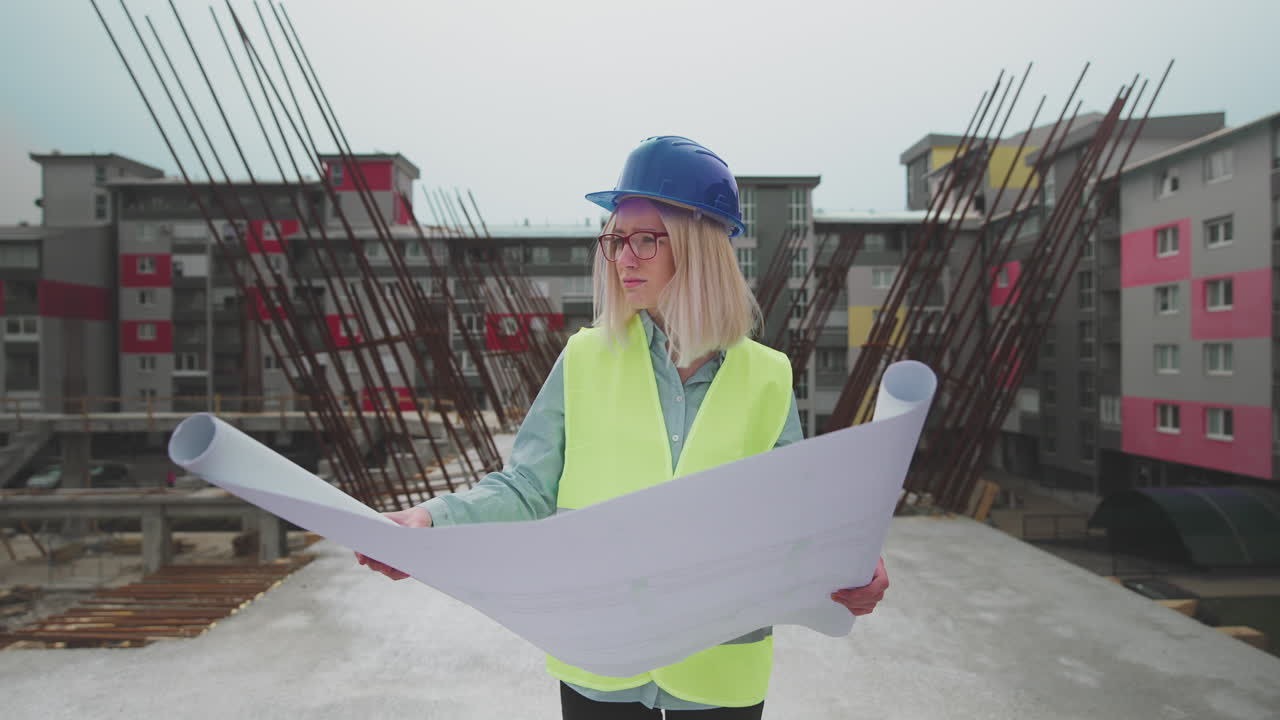 Female Engineer Reviewing Blueprints on Construction Site