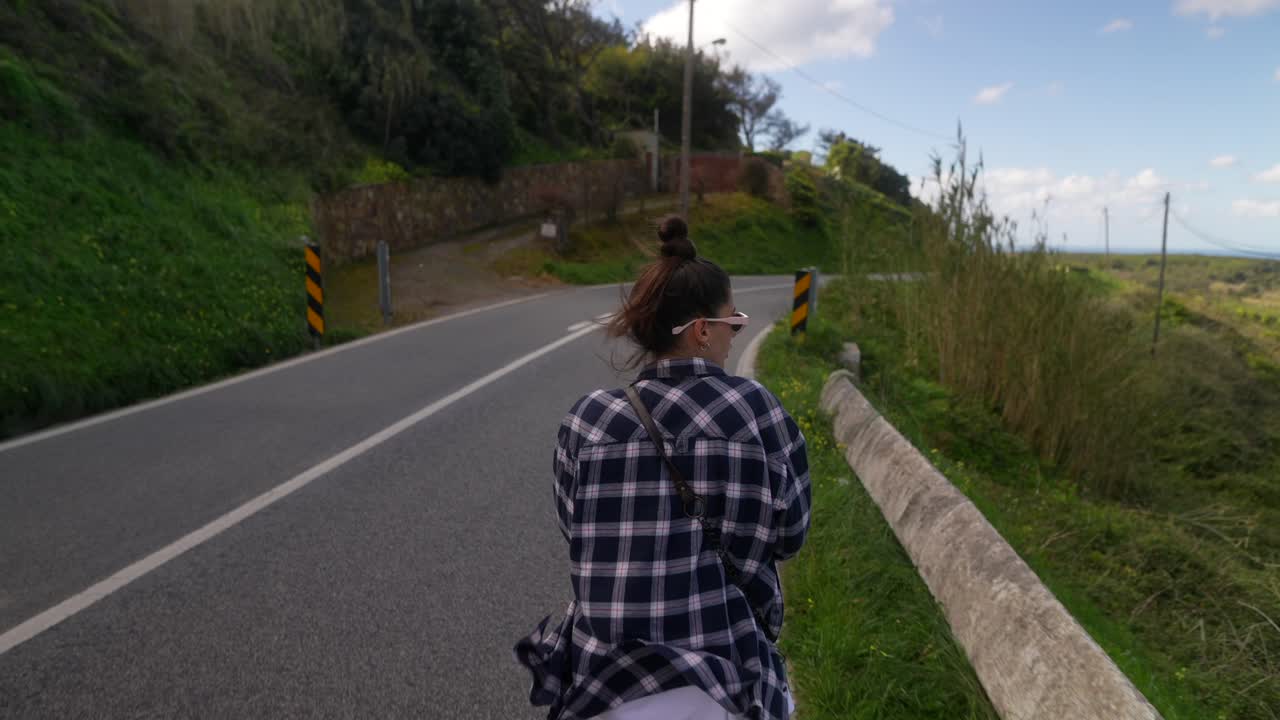 Woman Walking on a Scenic Country Road