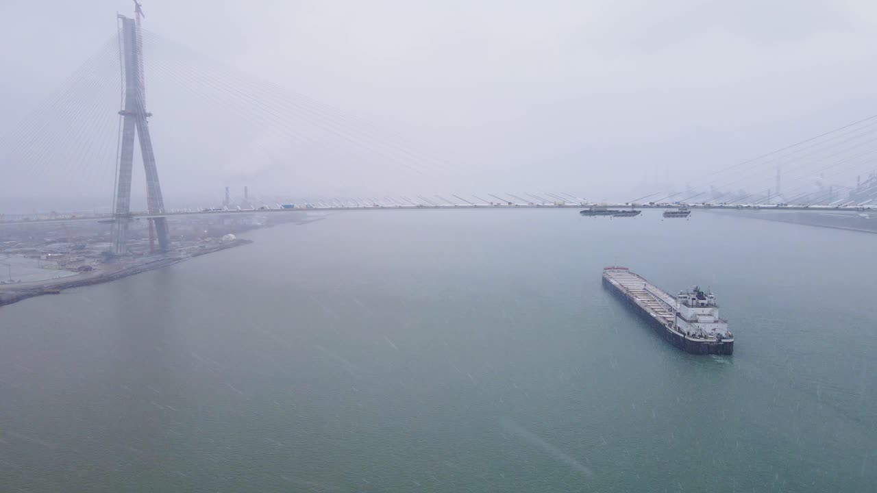 Bulk carrier passing under Gordie Howe International Bridge on Detroit River
