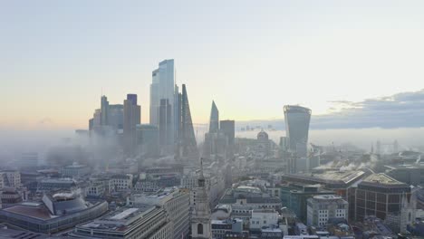 establishing aerial slider shot of london central business district foggy sunrise