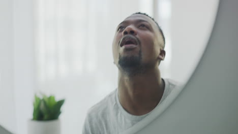 black man, rinsing mouth and mirror for dental