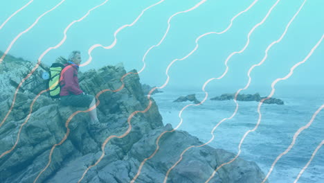male hiker sitting on rugged coast, displaying travel marketing data overlay and animated map