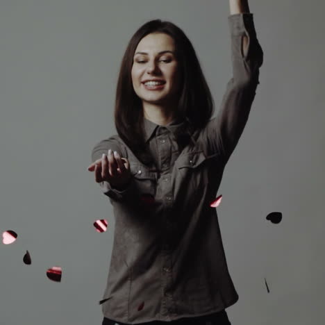 young woman catching paper hearts over white. slow motion square video