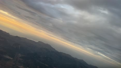 a pastel colors sky during a left turn shot at the golden minute from a jet cockpit