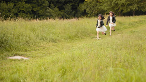 two girls running in a field