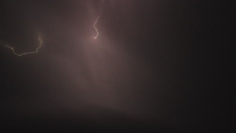 powerful forked lightning bolts flash across the dark evening sky