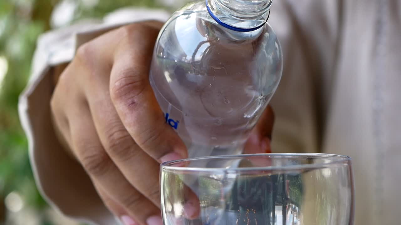 verter agua de la botella en el vaso