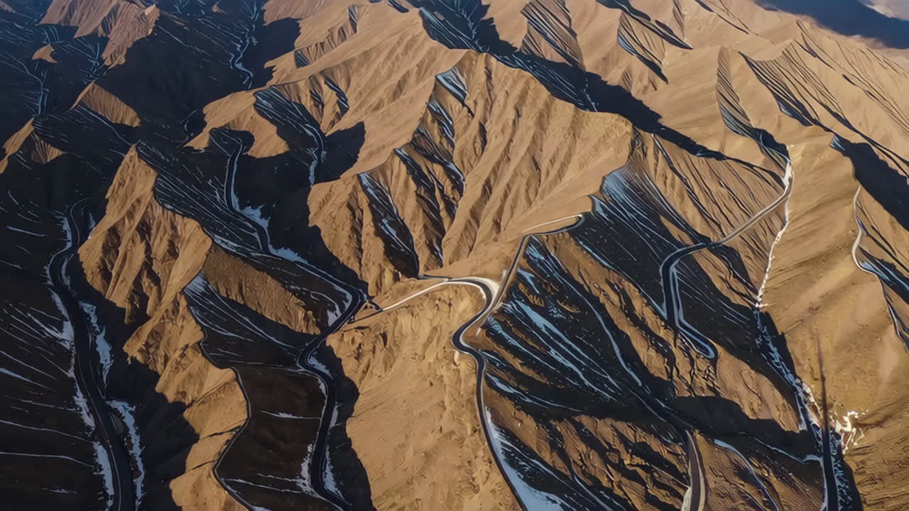 Aerial view of a winding mountain road in winter