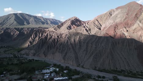 purmamarca route and town, hills of seven colors, aerial above argentine scenic landscape, panoramic of quebrada de humahuaca, drone shot