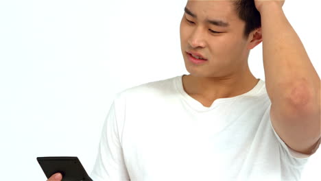 worried asian man using calculator