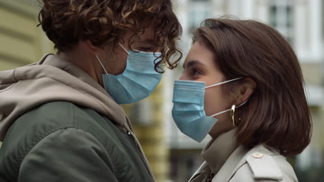 young couple wearing masks outdoor