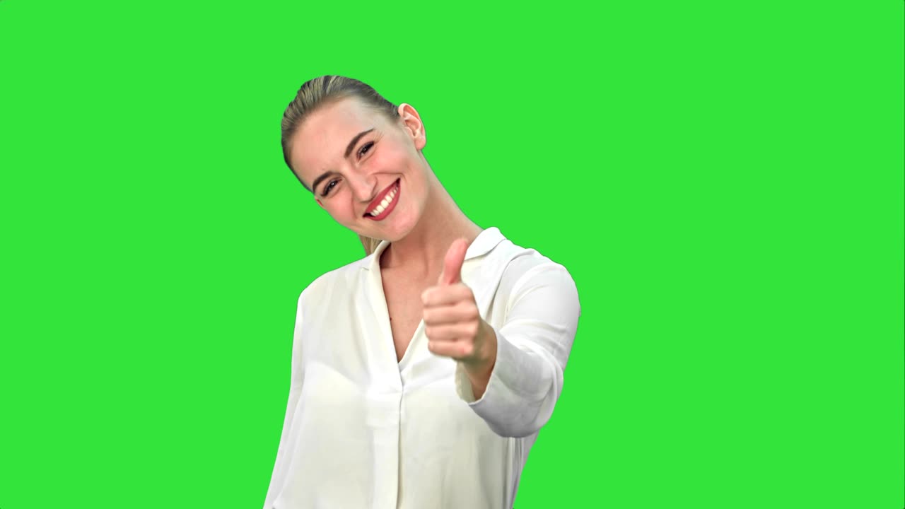 Happy excited woman showing approval hand gesture thumb up and smiling on a Green Screen, Chroma Key