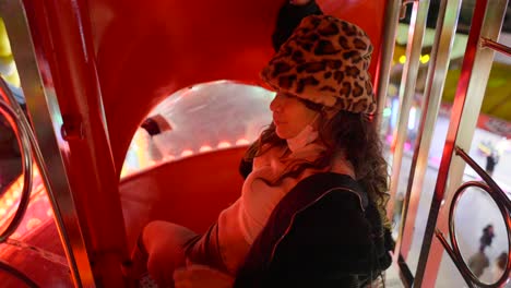 woman enjoying a funfair ride at night