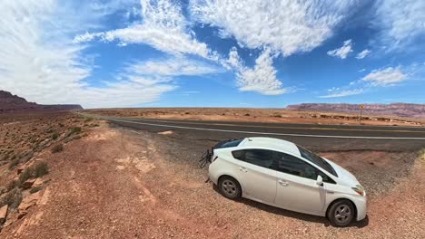 time lapse of a prius in front of a freeway in red rock desert of arizona
