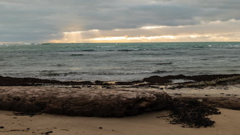 a mesmerizing time-lapse of sun rays piercing through beachside clouds in a captivating long shot