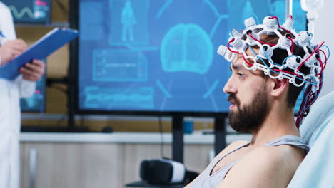 patient with brainwaves scanning headset sitting on bed