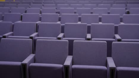 Pan-over-empty-seats-in-a-small-auditorium-or-theatre