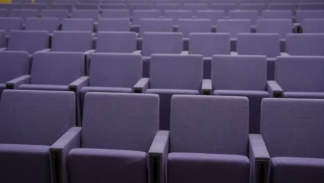 pan over empty seats in a small auditorium or theatre