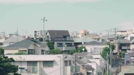 japanese house, buildings, and rooftops in ookayama town in meguro district, tokyo, japan at daytime.  - wide panning shot