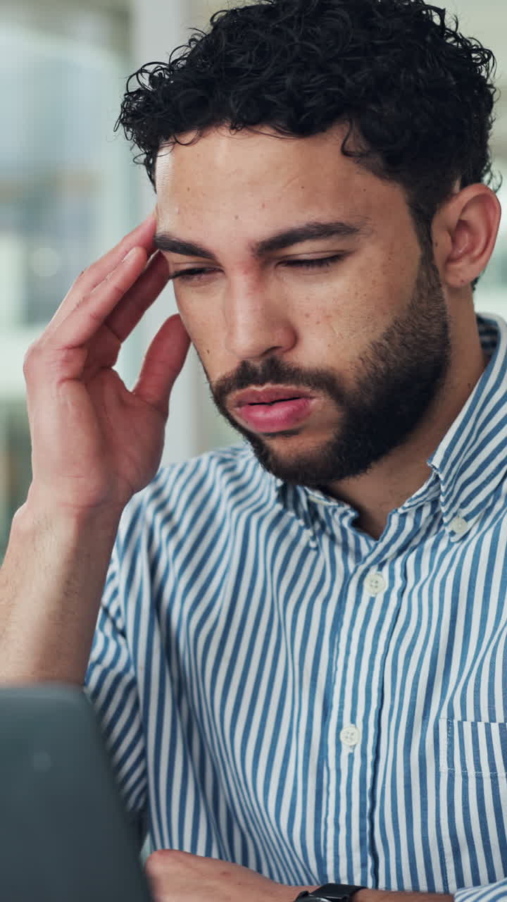 Young Man Experiencing Stress and Headache While Working