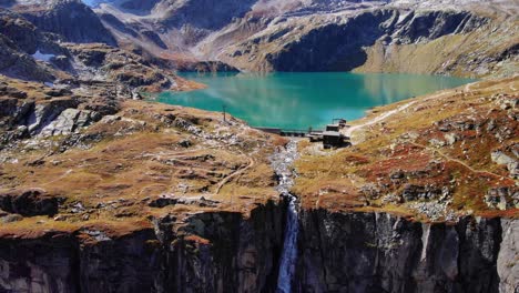 calm weisssee lake and the waterfall on the rugged canyon in salzburg, austria