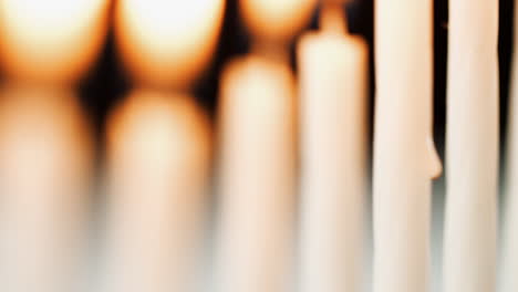 selective focus tilt shot of burning candles in a jewish menorah