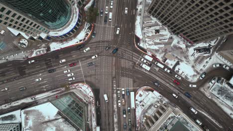 overhead vehicle traffic 4k time lapse winter drone shot canadian roadway trans highway one intersection portage avenue and main street capital city downtown winnipeg manitoba canada