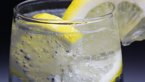 close-up of a glass of mineral water with lemon slices in