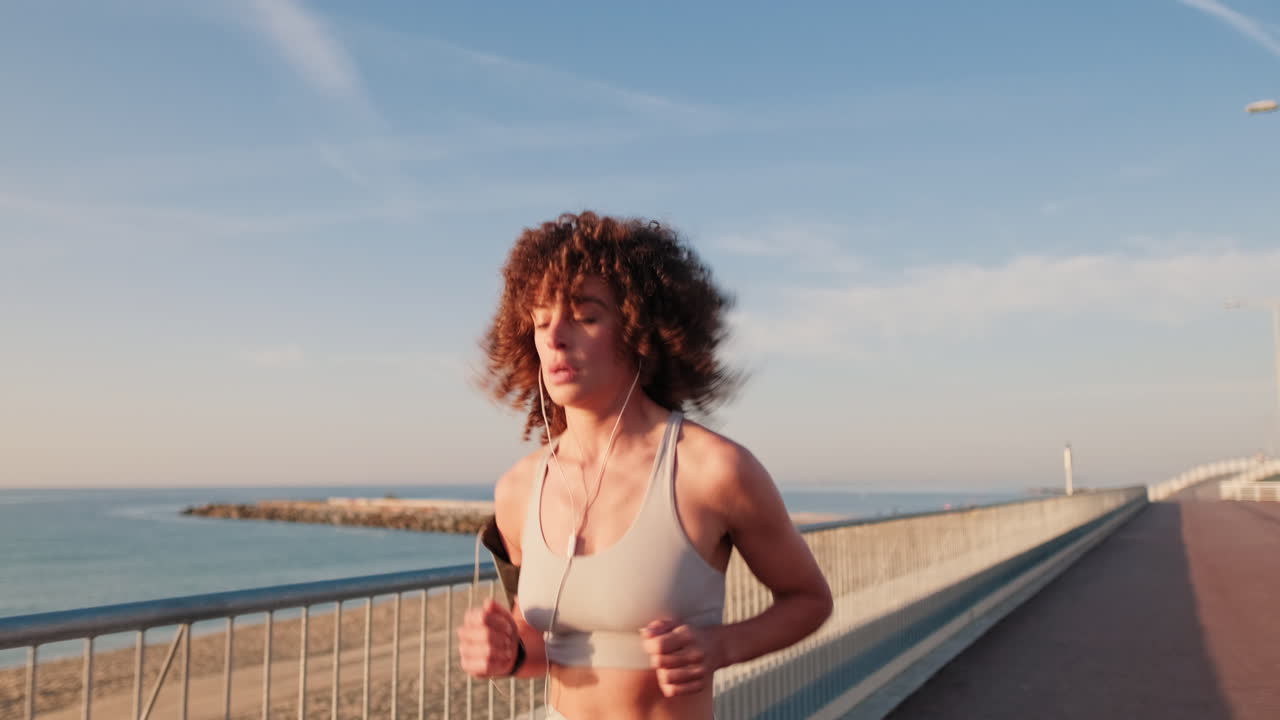 Young Woman Running By The Sea At Sunset