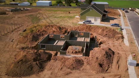 a drone shot spinning around a foundation and basement walls that had just been poured