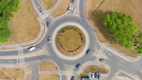 Cars-driving-on-5-way-roundabout,-aerial-top-down-view