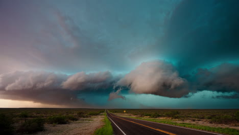 dramatic storm clouds over a long rural road