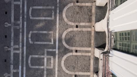 Aerial-straight-down-view-of-the-mirror-artwork-on-the-ground-reflecting-the-historic-structure-of-Cordoba-Cabildo-colonial-town-hall-at-San-Martin-plaza,-Argentina,-South-America