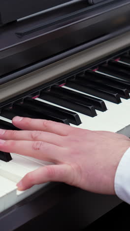 hands playing on a piano keyboard