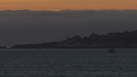 dramatic-and-wide-view-of-Lighthouse-with-some-boats-crossing-the-line-In-Guia,-Cascais,-Portugal