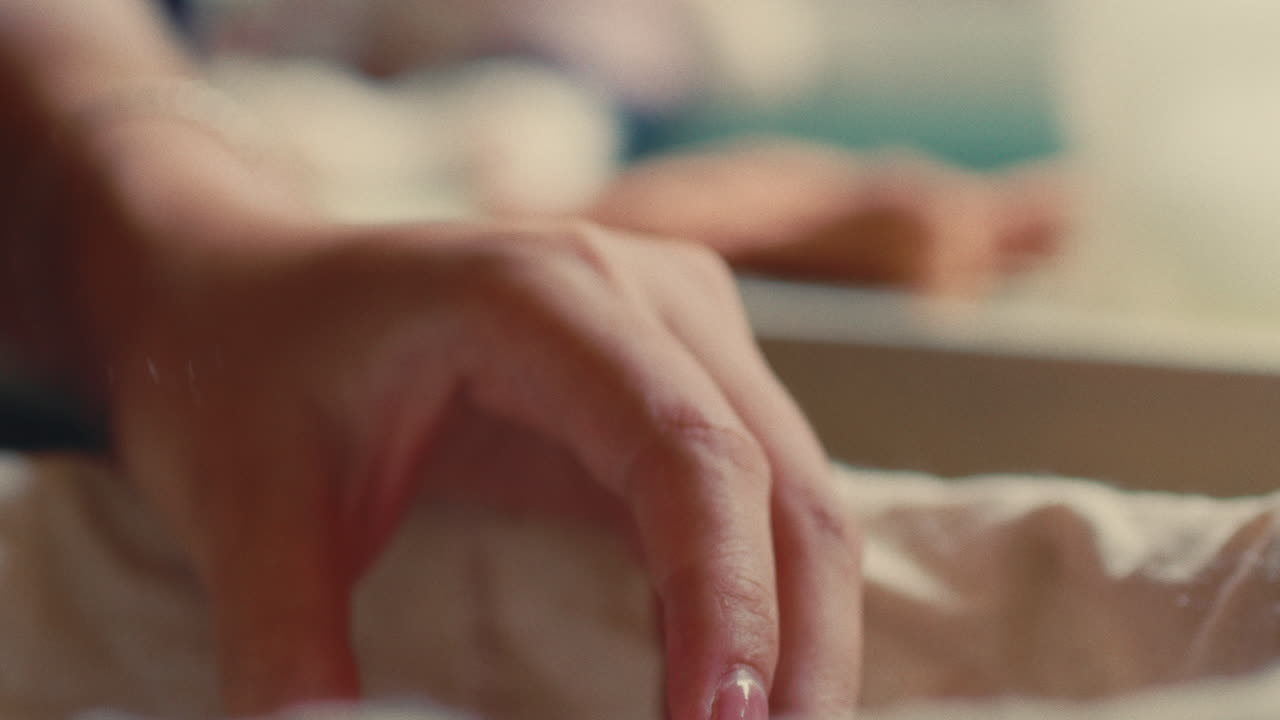 Person pouring fluffy white material into a container