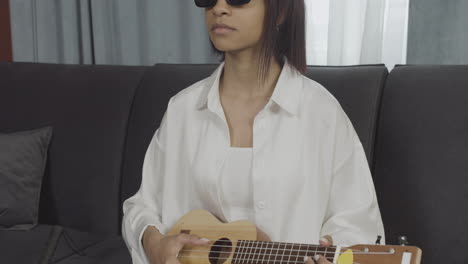 close up view of young blind woman sitting on a sofa