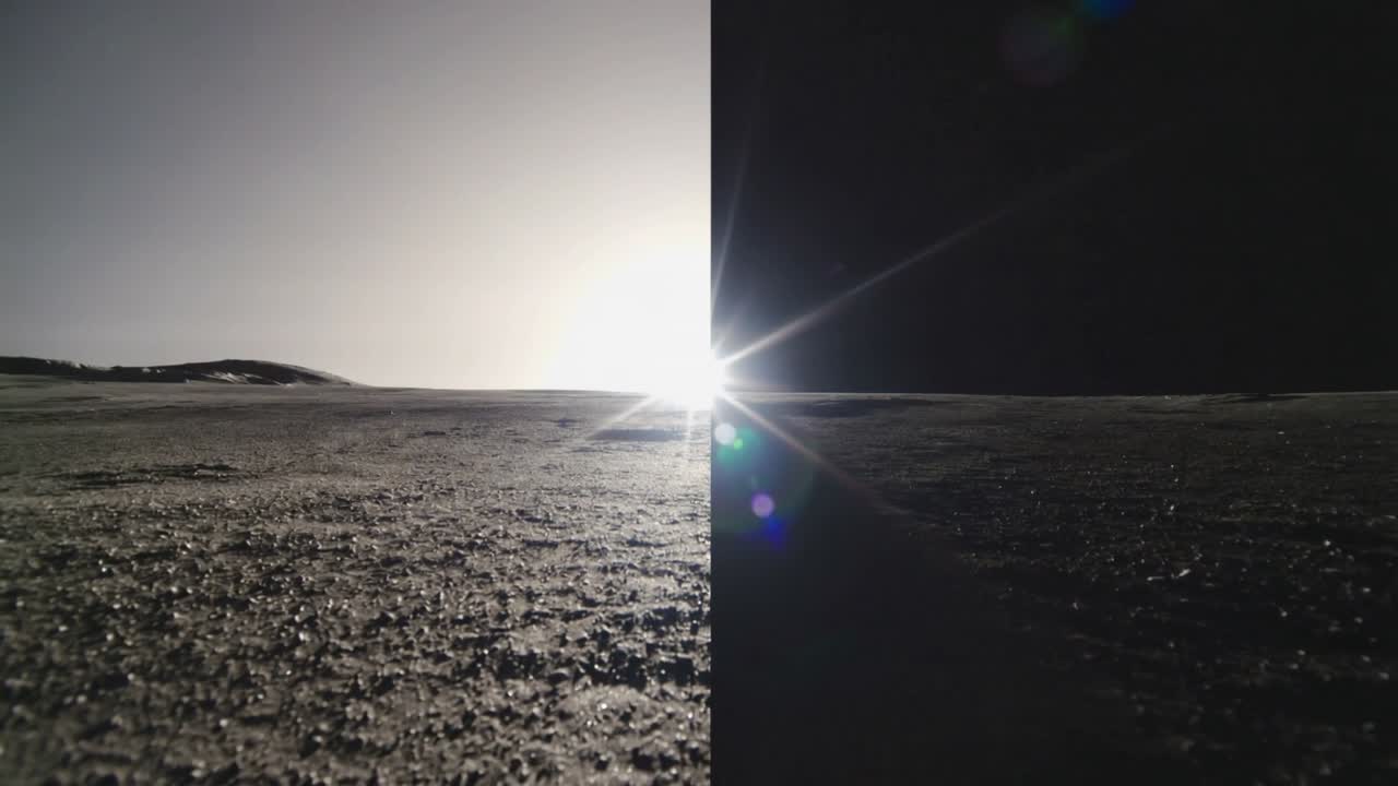 Nærmer seg horisonten, glødende sol på en sprekk som produserer skiftende linseglimt over teksturert bakke.